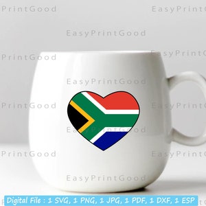 May include: White ceramic mug with a heart-shaped design featuring the South African flag. The flag is red, yellow, green, and blue with a black triangle in the center.