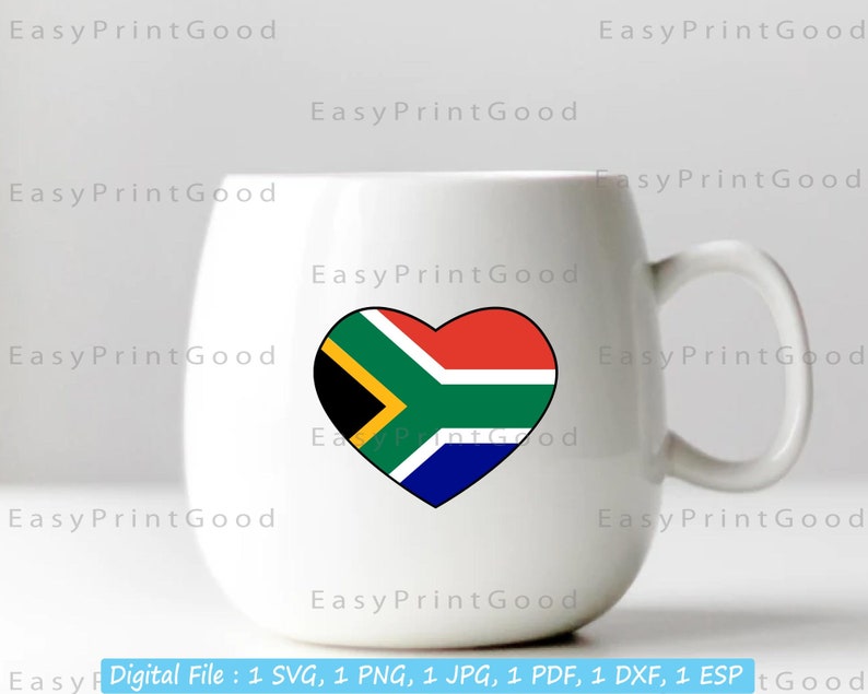 May include: White ceramic mug with a heart-shaped design featuring the South African flag. The flag is red, yellow, green, and blue with a black triangle in the center.