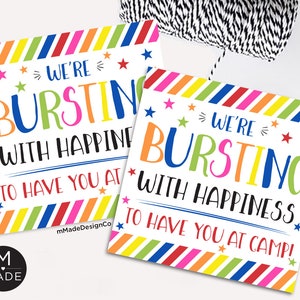 May include: Two printable signs with a colorful striped border and white background. The text on the signs reads "We're bursting with happiness to have you at camp!"