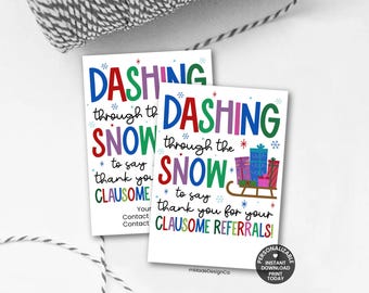 May include: Two white rectangular cards with colorful text that reads "DASHING through the SNOW to say thank you CLAUSOME". The cards have a winter holiday theme with snowflakes and a sleigh.