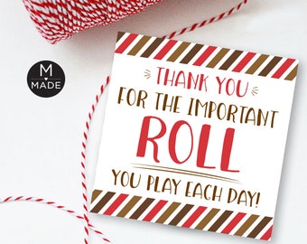 May include: A white card with red and brown stripes around the edges. The card says "Thank you for the important roll you play each day!" in brown and red text.