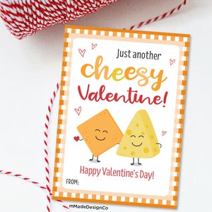 May include: A Valentine's Day card with a cheesy theme. The card features two cartoon cheese wedges with smiling faces. The text on the card reads "Just another cheesy Valentine!" and "Happy Valentine's Day!"