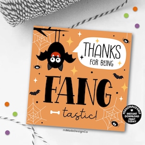 May include: Orange square card with a black bat hanging upside down, spiders, and the words "THANKS FOR BEING FANGtastic!" in white and black. The card has a Halloween theme with spiderwebs and stars.