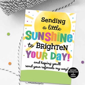 May include: A white card with the text "Sending a little SUNSHINE to BRIGHTEN YOUR DAY!" in various colors. A yellow sun graphic is at the top. The card also includes the text "and hoping you'll send your referrals my way!"