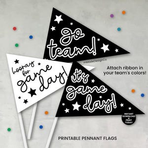 May include: Three printable pennant flags with white text and star accents. Two are black, and one is white. The flags read "Go team!", "It's game day!", and "Hooray for game day!" with the option to add team colors.