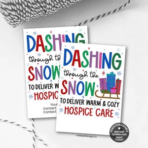 May include: Two white rectangular cards with colorful text that reads "Dashing through the snow to deliver warm & cozy hospice care." The cards have snowflakes and gift illustrations.