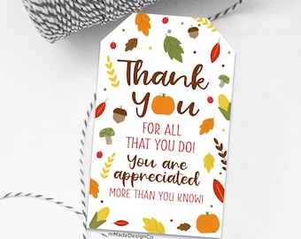 May include: A white tag with the words "Thank You" in brown script, with a pumpkin graphic. The tag is decorated with fall leaves, acorns, and the text "FOR ALL THAT YOU DO! You are appreciated MORE THAN YOU KNOW!"