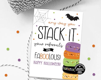 May include: A white Halloween-themed card with the text "any way you STACK IT your referrals ARE FABOOLOUS! HAPPY HALLOWEEN!". The card features a stack of colorful macarons and a bat silhouette. A spiderweb and confetti dots are also present.