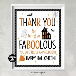 May include: A framed Halloween-themed print with a white border and black and white striped inner border. The print features orange and black text that reads "THANK YOU for being so FABOOLOUS! HAPPY HALLOWEEN!" with Halloween graphics.