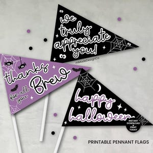 May include: Three triangular pennant flags with Halloween and appreciation messages. One is purple with "thanks Brew" and spider web graphics. The other two are black with white text that says "we truly appreciate you!" and "happy Halloween".