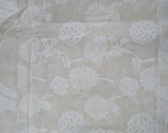 May include: White fabric with a delicate embossed floral pattern. The fabric has a subtle sheen and a soft texture.