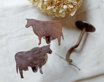 Large old iron hooks with cow motif old hooks made of iron rust patina
