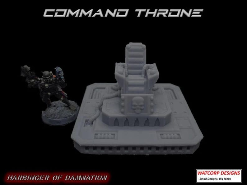 May include: A grey resin miniature command throne featuring a skull emblem on the base, accompanied by a small soldier figurine. The text COMMAND THRONE, HARBINGER OF DAMNATION, and WATCORP DESIGNS - Small Designs, Big Ideas are visible.