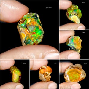 May include: A collection of raw opals, each held by a hand, showcasing vibrant colors. The opals display a spectrum of hues, including green, orange, and yellow, with a shimmering, iridescent quality. The text "SM-256" is visible.