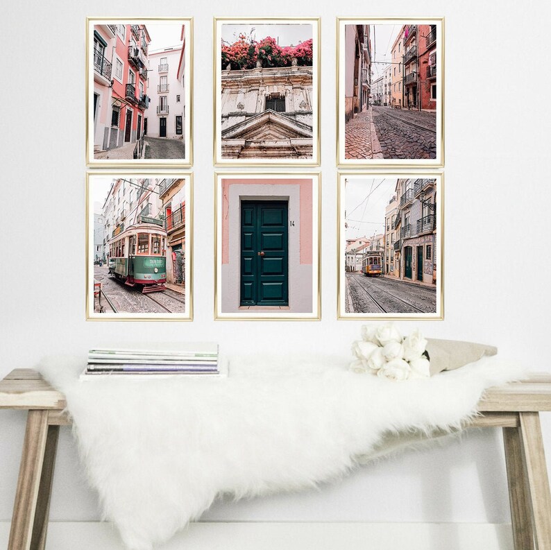 May include: Six framed prints of Lisbon, Portugal, featuring a street scene with a tram, a door, and a building with pink flowers.