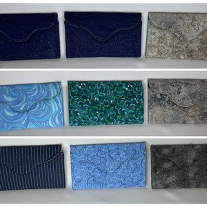 May include: Nine different fabric swatches for a wallet or purse. The swatches are in various colors and patterns, including blue, green, gray, and white.