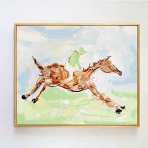 May include: A framed painting depicting a brown horse galloping across a light green field with a rider wearing a bright green shirt and white pants. The background features soft, abstract brushstrokes in shades of light blue and white.