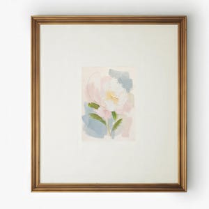 May include: A framed painting featuring an abstract floral subject with thick, textured brushstrokes in shades of white, soft pink, pale yellow, and muted blue, set within a wide off-white mat and a metallic gold-toned rectangular frame.