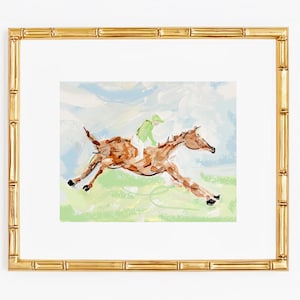 An impressionist painting of a brown horse and jockey in a bamboo-style gold frame against a white background.