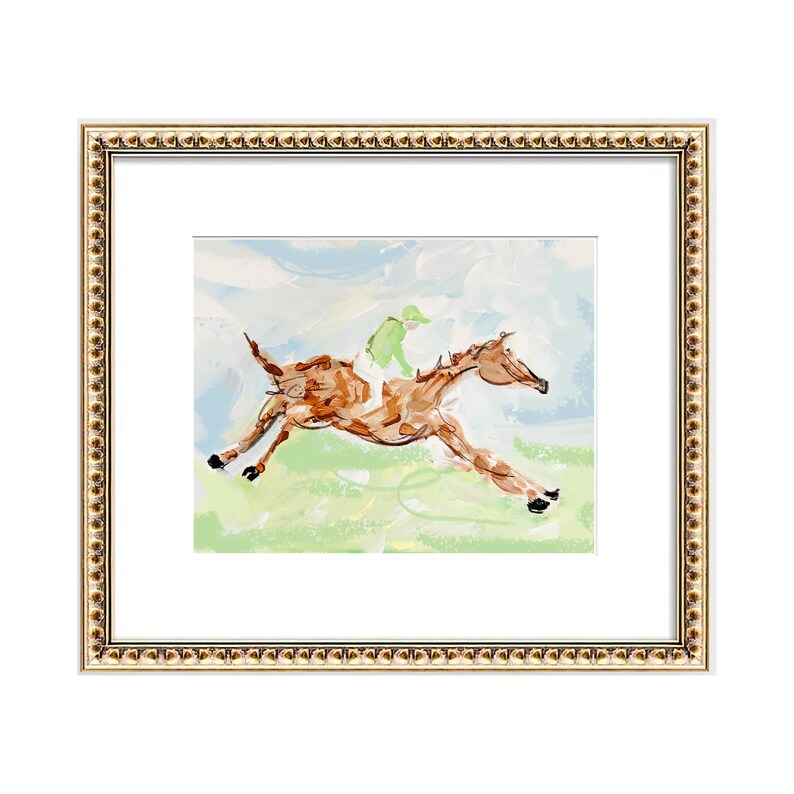 A painting of a racing horse and jockey in a decorative gold frame with a white mat.
