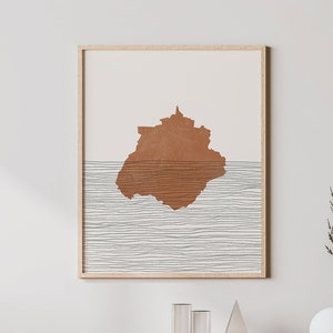 May include: A minimalist living room interior with a wooden console table, a white chair, and a framed print of a brown abstract shape over a white and gray striped background.