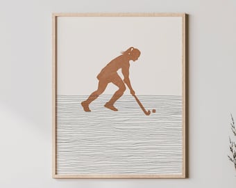 May include: A minimalist art print featuring a brown silhouette of a person playing field hockey on a white and gray striped background.