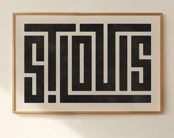 May include: A framed print with a black and white geometric design of the word "ST. LOUIS". The print is hanging on a white wall above a record player, a stack of vinyl records, and a record album cover featuring the Beach Boys.