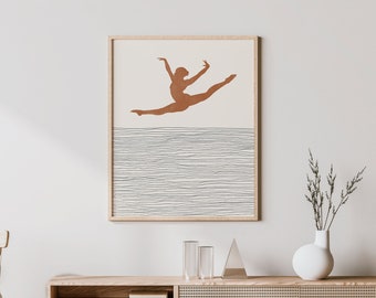 May include: A framed print of a brown silhouette of a dancer leaping against a background of thin, white lines. The print is hanging on a white wall above a light wood cabinet with a woven rattan front.