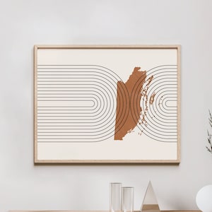 May include: A framed abstract print with a brown and white color scheme. The print features a series of overlapping arches and a brown abstract shape in the center.