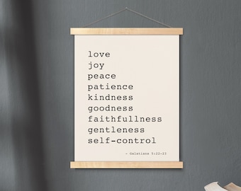 May include: A framed print with a white background and black text listing the fruits of the spirit: love, joy, peace, patience, kindness, goodness, faithfulness, gentleness, and self-control. The text is from Galatians 5:22-23.