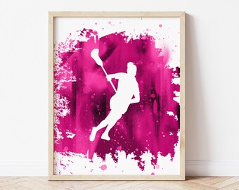 May include: A white silhouette of a lacrosse player holding a lacrosse stick, set against a pink watercolor background with splatters of white paint.