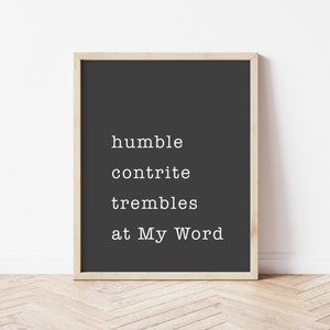 May include: A framed black and white print with the text "humble contrite trembles at My Word" on a dark gray background.