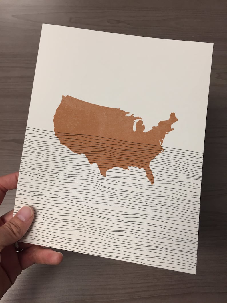 May include: A brown outline of the United States of America on a white background with black wavy lines.
