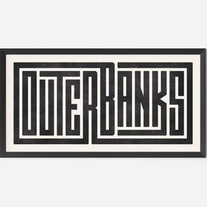 May include: Black and white graphic print of the word "OUTER BANKS" in a bold, geometric font style. The print is framed in a black frame.