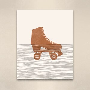 Op de afbeelding: Een bruine rol skate met zwarte wielen op een witte achtergrond met zwarte lijnen.