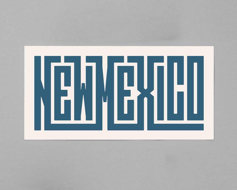 May include: A rectangular sticker with the word "NEW MEXICO" in a stylized, geometric font. The letters are a deep teal color against a cream-colored background. The sticker is rectangular and has a clean, modern design.