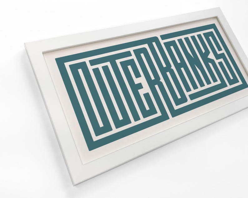 May include: A white framed print with the word "OUTER BANKS" in teal blue, stylized with a geometric pattern.