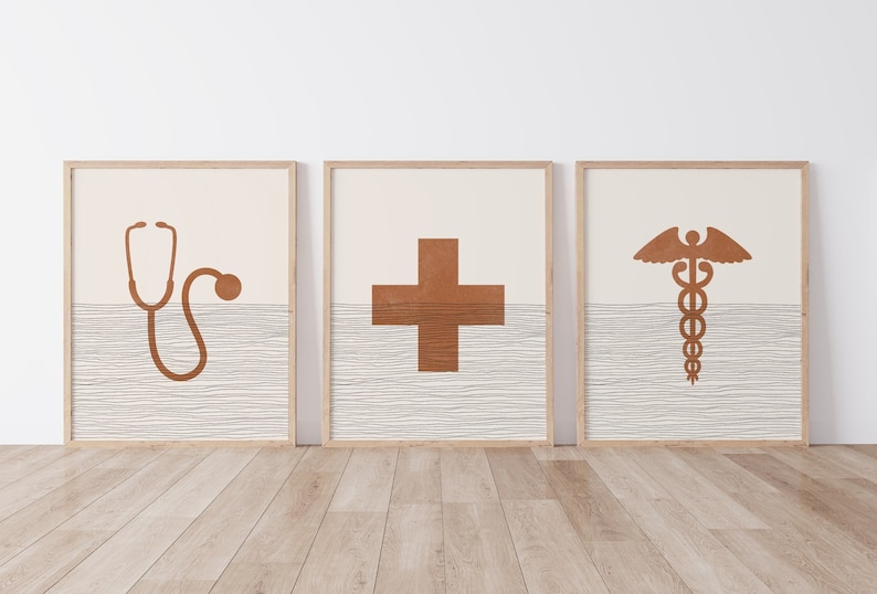 May include: Three framed prints with a medical theme. The prints feature a stethoscope, a cross, and the caduceus symbol. The prints are on a white background with a brown wood grain texture.