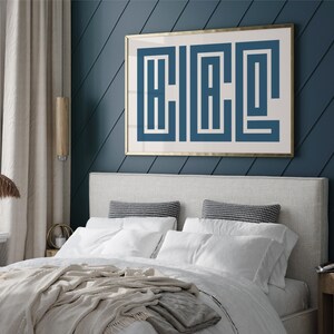 Puede incluir: Un dormitorio con una cabecera blanca y una obra de arte enmarcada con estampado geom&eacute;trico blanco y azul en una pared azul oscuro. La cama est&aacute; hecha con ropa de cama blanca y una manta beige.