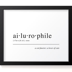 May include: Black and white framed print with the word "ailurophile" defined as "a cat fancier; a lover of cats".