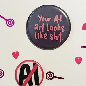 May include: Two round buttons with text and a graphic. One button is dark purple with pink text that reads "Your AI art looks like shit." The other button has a red circle with a line through the letters "AI."