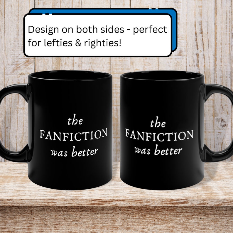 May include: Two black coffee mugs with white text that reads "the FANFICTION was better" on each side. The mugs are on a wooden surface.