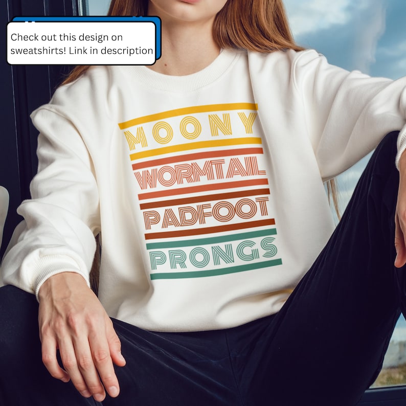 May include: White sweatshirt with a retro-style graphic design featuring the names "Moony", "Wormtail", "Padfoot", and "Prongs" in colorful stripes.