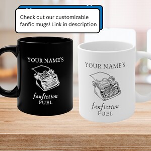 May include: Two ceramic mugs, one black and one white, with a typewriter graphic and the text "YOUR NAME'S fanfiction FUEL".