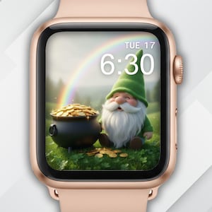 May include: A rose gold Apple Watch displays a whimsical scene. The watch face features a cartoon gnome with a white beard and green hat, sitting near a pot of gold and a rainbow. The time is 6:30, and the date is Tuesday, the 17th.