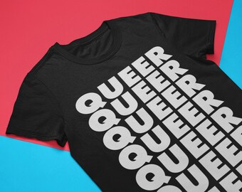 May include: Black t-shirt with the word "QUEER" repeated in white text, stacked vertically down the front of the shirt.