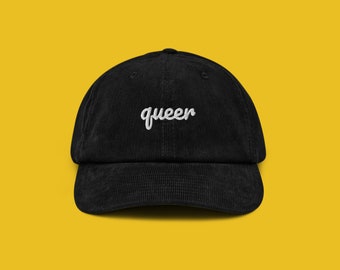 May include: Black corduroy baseball cap with white embroidered text that says "queen".