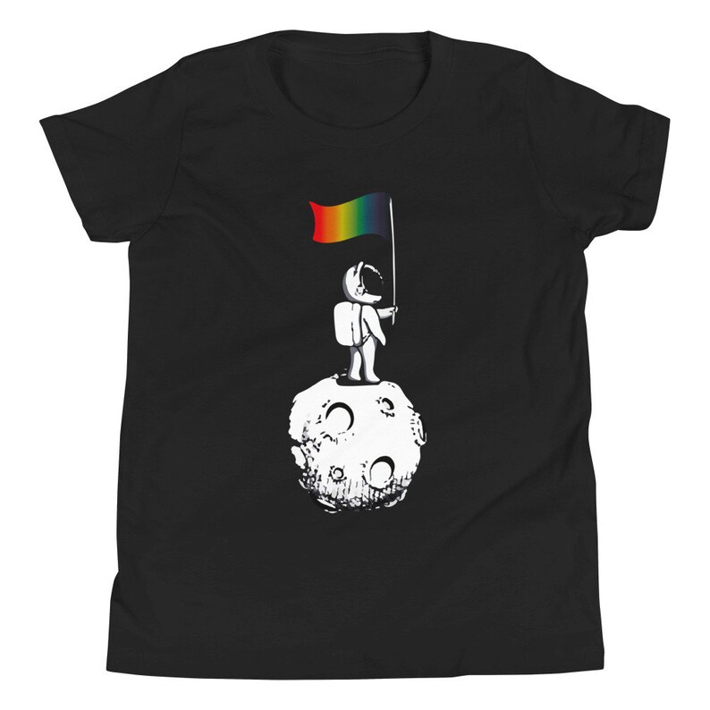 May include: A black t-shirt featuring a graphic of an astronaut standing on the moon holding a rainbow flag.