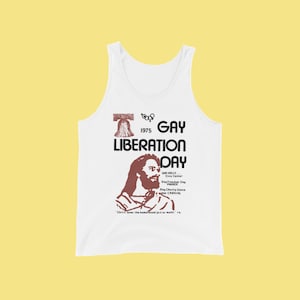 May include: White tank top with a red and black print of a bell, the text "Gay Liberation Day 1975", and a drawing of Jesus. The text below the drawing reads "Gay Rally Civic Center Gay Freedom Day Parade Gay Charity Dance and Carnival. "Christ loves the homosexual just as much." -cb"