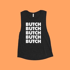 May include: A black sleeveless muscle tank top with the word "BUTCH" repeated five times in white text.